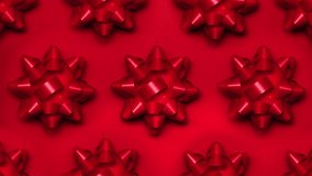 Set of foil spinning bows isolated on red background. Ballet of present decoration for holiday. Gift artistry, stop motion animation magic. - Powered by Shutterstock - Get 15% off with code: PIKWIZARD15