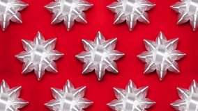 Set of foil spinning white bows isolated on red background. Ballet of present decoration for holiday. Gift artistry, stop motion animation magic. - Powered by Shutterstock - Get 15% off with code: PIKWIZARD15