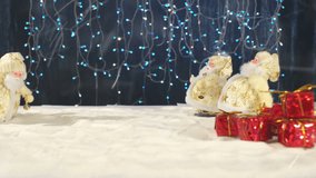 Three funny Santa Clauses musicians with their gifts celebrating and congratulating in the whirling snow and at the end the inscription Happy New Year. Cheerful stop-motion animation on New year.