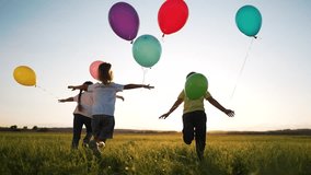 Happy family concept.Child run together and play in nature in summer with balloons.Balloons at sunset, celebration of summer freedom in hand of child.Kids run and play with colorful balloons in park - Powered by Shutterstock - Get 15% off with code: PIKWIZARD15