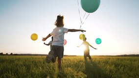 Happy family concept.Child run together and play in nature in summer with balloons.Balloons at sunset, celebration of summer freedom in hand of child.Kids run and play with colorful balloons in park - Powered by Shutterstock - Get 15% off with code: PIKWIZARD15