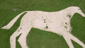 Aerial rising reverse reveal clip of the chalk landmark Roundway White Horse near Devizes, Wiltshire, England, UK
