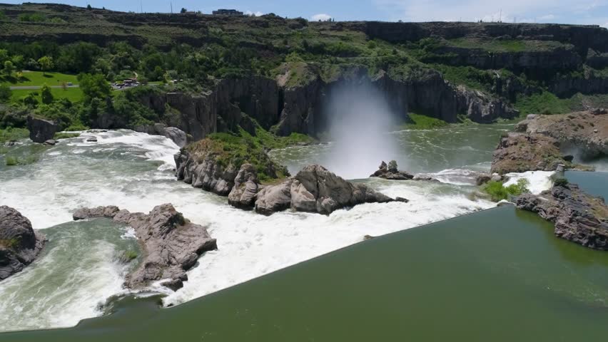 A 4K drone shot of Shoshone Falls, a raging waterfall, which often reflects rainbows, located along the Snake River, only 3 miles away from Perrine Bridge and Twin Falls, Idaho.