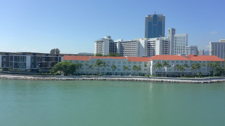 Strafing sideways across the shoreline of Georgetown, where the grand hotels sit on the water front near the jetty, or pier.