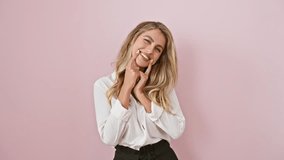 Attractive young blonde woman in shirt, playfully forcing a cheeky smile and pointing her fingers, radiating joy over an isolated pink wall background - Powered by Shutterstock - Get 15% off with code: PIKWIZARD15