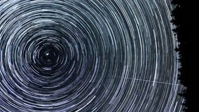 Time lapse of Star trails in the night sky. Stars move around a polar star, vertical footage - Powered by Shutterstock - Get 15% off with code: PIKWIZARD15