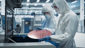 Semiconductor Production Process At Electronics Factory: Two Scientists In Sterile Suits Taking Out Silicon Wafer From Soldering Jet Printer And Checking It. Engineers Creating Hardware For Computers. - Powered by Shutterstock - Get 15% off with code: PIKWIZARD15