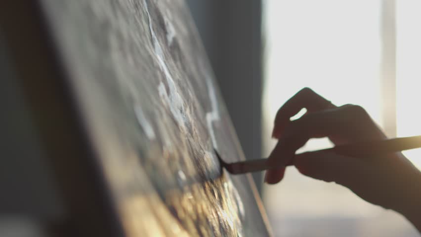 The workflow of creating an artistic masterpiece. The artist in the studio is immersed in her creative process, using various techniques and materials. A female artist in creative self-isolation