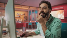 Attractive Young Man Using Desktop Computer while Sitting in Stylish Cozy Colorful Studio. Male Shopping Online from Home. Browsing Internet, Using Social Networks, Writing Project - Powered by Shutterstock - Get 15% off with code: PIKWIZARD15