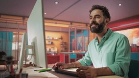 Attractive Young Man Using Desktop Computer while Sitting in Stylish Cozy Colorful Studio. Male Shopping Online from Home. Browsing Internet, Using Social Networks, Writing Project - Powered by Shutterstock - Get 15% off with code: PIKWIZARD15