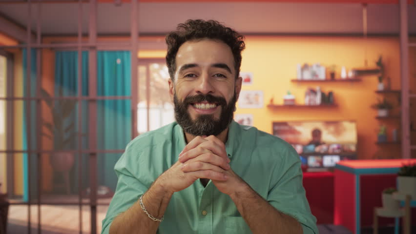 Stylish Creative Man Having a Video Call from Home Living Room with Bright Colors. Happy Male Talking to Family and Friends Online, Smiling and Telling Interesting Stories. POV from Camera Footage