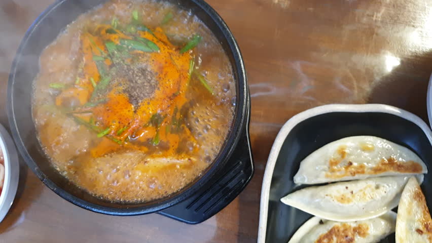 Eating boiling blood suasage red soup with pig