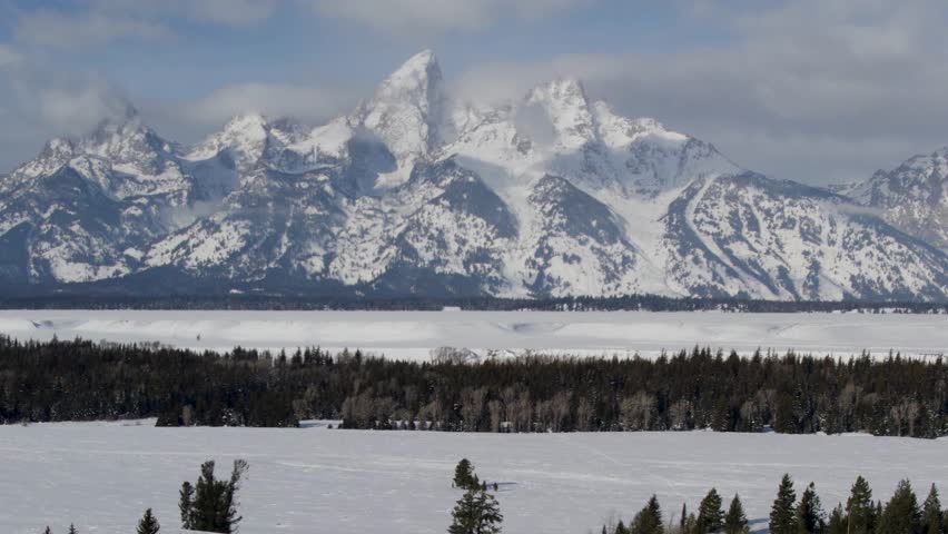A 4K drone shot of The Grand Teton, the largest and tallest mountain top of the Teton range, in Grand Teton National Park in Northwestern Wyoming.