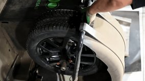 Tire balancing car service. Tire fitting. Car service. The wheel is spinning for balancing in a tire shop. Close up. HD