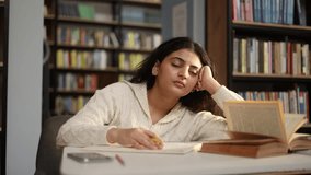 Boring tired student girl falling asleep during study at university library Stressed curly young woman exhausted from remote distance work or education and hard program indoors - Powered by Shutterstock - Get 15% off with code: PIKWIZARD15