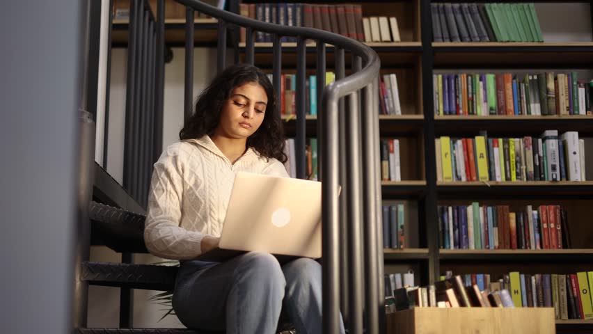 Unhappy indian young woman student with closing eyes suffering headache painful feelings chronic migraine high or low pressure vision problem after hard laptop computer work at university library Royalty-Free Stock Footage #3392765815