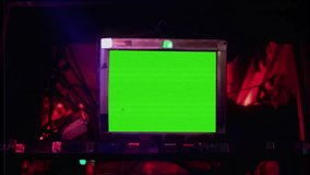 Retro Monitor Green Screen Close Up Zoom In Vintage Television Neon Lights. Vintage monitor green screen with static noise lighten by neon lights, zoom in. Old technology