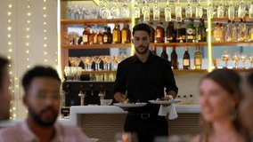 Couple of friends, restaurant and waiter with food for dinner, fine dining and date night in hospitality services. Young group of people and worker giving plate at tablet for happy customer service - Powered by Shutterstock - Get 15% off with code: PIKWIZARD15