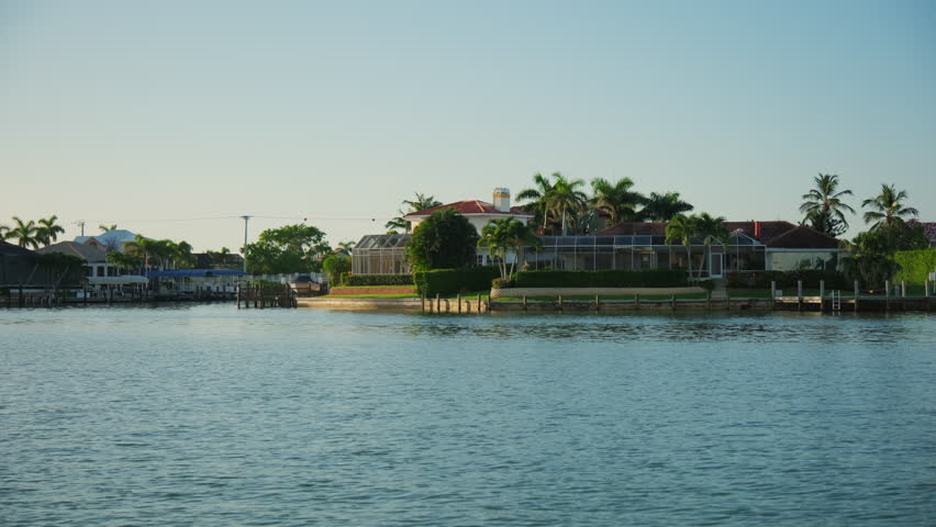 Florida coast with houses and palm trees, view from a sail boat on sunny day