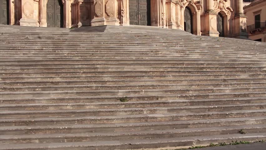 modica sicily italy town san giorgio cathedral medium shot tilt up from stairs to top