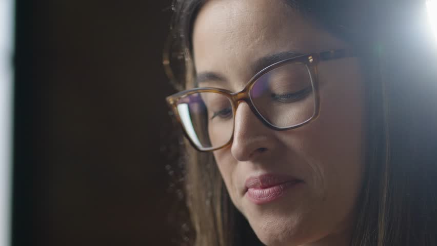 Close up portrait of cheerful beautiful female in good mood with camera standing indoors. Happy pretty young caucasian woman taking photo. Photographer taking pictures. 
