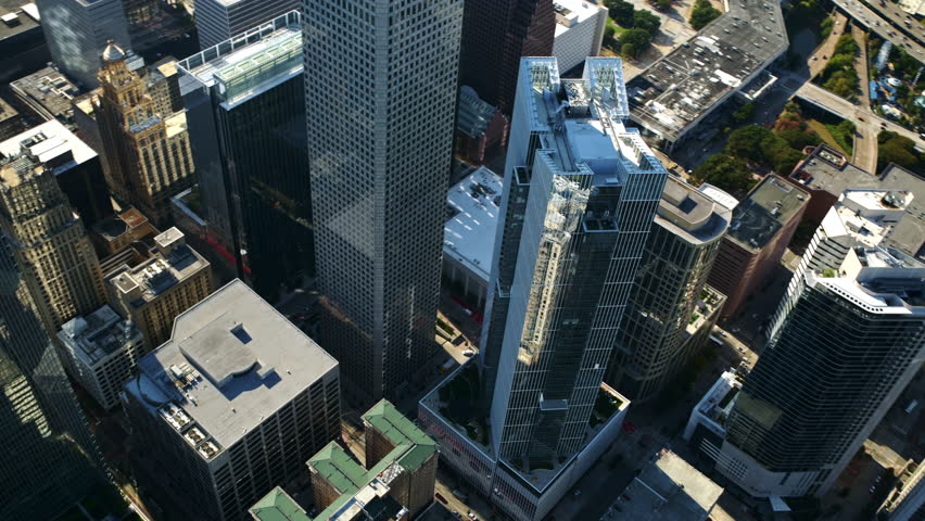 Aerial view of the skyscrapers and city streets from directly above downtown Houston, Texas shot via helicopter from an altitude of about 1000 feet