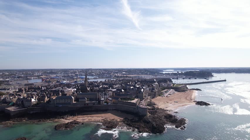DRONE AERIAL FOOTAGE: The Breton Coastal Medieval Fortified City of Saint-Malo, France. The ramparts of Saint-Malo represent granite walls that surround the city and are built on a rock. Royalty-Free Stock Footage #3392964509