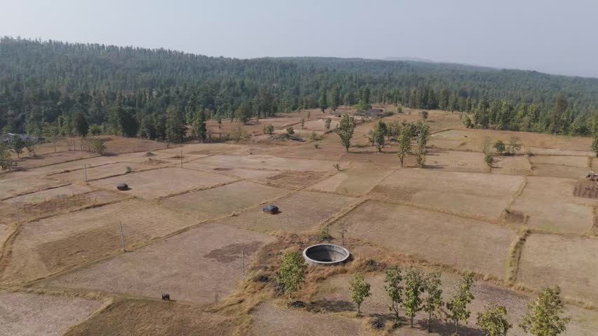 Water well between agriculture land drone view. After harvesting agriculture field drone view.