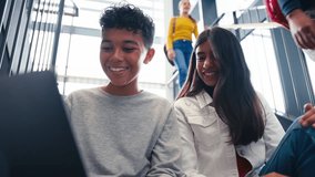 Male and female secondary or high school pupils inside school building on stairs with digital tablet - shot in slow motion - Powered by Shutterstock - Get 15% off with code: PIKWIZARD15