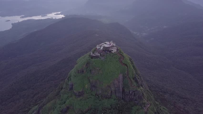 Top view on mountain with green forest and temple. Adams Peak. Slow move camera. D-log.