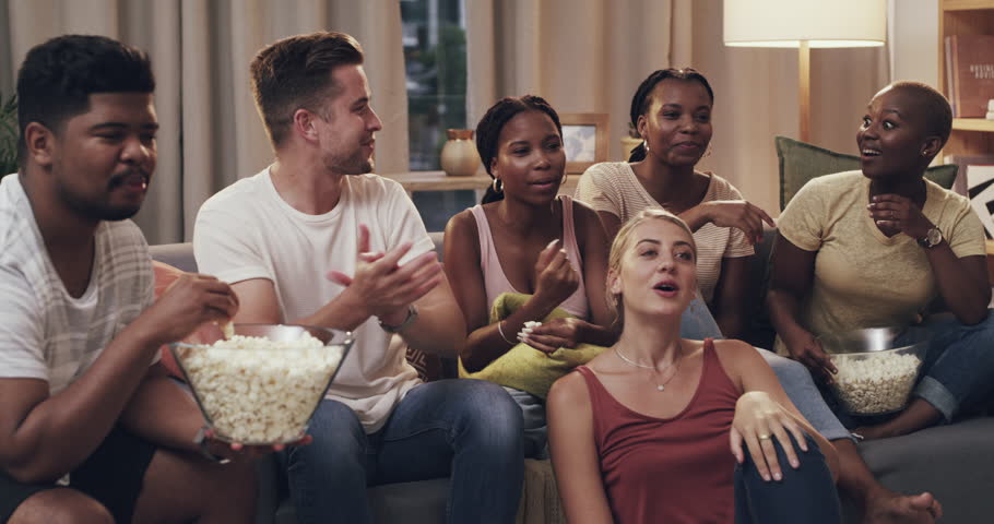 Conversation, popcorn and friends watching movie on sofa in living room for entertainment together. Happy, snack and group of young people talking, bonding and streaming show, film or video at home.