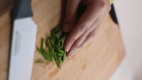 Vertical video, Cut scallion with knife, wood cutting board, good lighting, suit for cooking video, close up shot