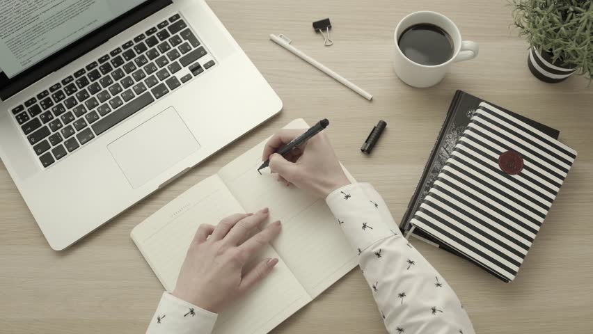 Female hands write to do list on blank notepad. Setting goals concept. Top view desktop. Productivity and success. Office workspace flatlay | Shutterstock HD Video #33932410