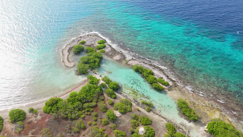 Aerial establishing view of Doggy beach clear turquoise Caribbean waters by Jan Thiel and Zanzibar, Curacao