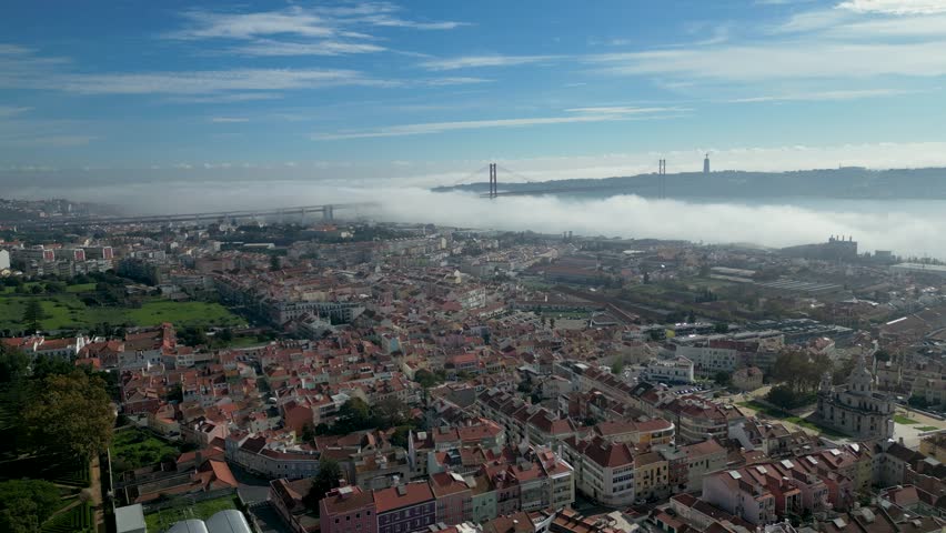 Aerial establish shot Lisbon Portugal and 25 de Abril Bridge suspension bridge over Tagus River Royalty-Free Stock Footage #3393355179