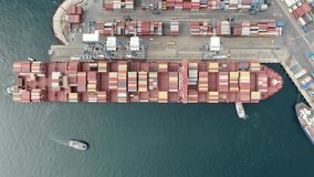 Aerial drone top view video of fully loaded container ship sailing in the sea for logistics import export, shipping or transportation. oil ship aerial view