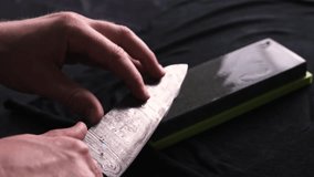 Man Hands Sharpening Kitchen Knife With Whetstone, Slow Motion Video, Close Up View