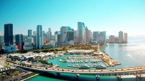 Modern downtown skyscrapers along Miami river. Aerial video of yachts at a miami florida marina. 