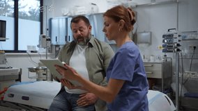 Female doctor consulting with overweight patient, discussing test result in doctor office. Obesity affecting middle-aged men's health. Concept of health risks of overwight and obesity. - Powered by Shutterstock - Get 15% off with code: PIKWIZARD15