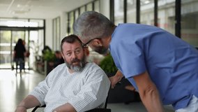 Male nurse pushing a patient in a wheelchair along a hospital corridor. Overweight patient feeling anxious and has health concerns. - Powered by Shutterstock - Get 15% off with code: PIKWIZARD15