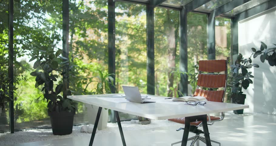 bright modern design business office space with nobody in it and large sunlight windows and garden view