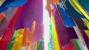 Close-up of many colorful ribbons hanging from the ceiling and bright light from a long lamp. Multicolored ribbons in the shape of a rainbow. abstract background. - Powered by Shutterstock - Get 15% off with code: PIKWIZARD15