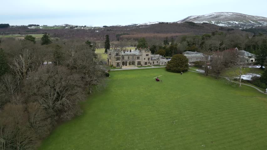 Country house luxury estate england uk forward aerial drone shot with helicopter rotors spinning turning blades