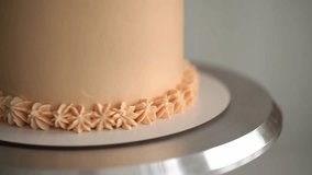 woman prepares cake and pastries. close-up of a cake.beige cake.slow motion video.High-quality shooting in 4K format
