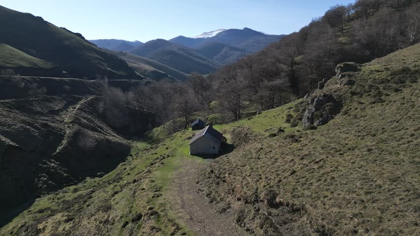 Traditional CAYOLAR : french Basque Country mountain pasture shelter (or hut) used by shepherds with the adjoining pen designed to park the sheep in summer. Royalty-Free Stock Footage #3393791051