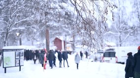 Snowfall at a festive Christmas market at winter time. Happy people walking to shops. Blurry back ground Copyspace 4k video.