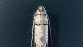 Aerial drone top view video of fully loaded container ship sailing in the sea for logistics import export, shipping or transportation. oil ship aerial view