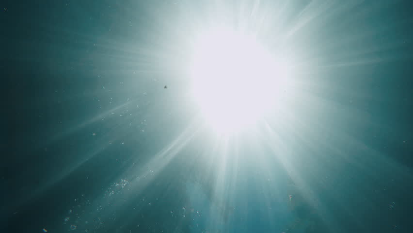 Beautiful sunshine seen through water like miracle. Texture of underwater motions and ray of sun through surface of sea. Peaceful natural background. Film grain pixel texture. Brilliant. Underwater Royalty-Free Stock Footage #3394084449