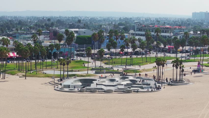 Aerial view of the skate board park in Venice beach at sunset, California, USA. Beautiful Venice beach vibe. People skating in Los Angeles.