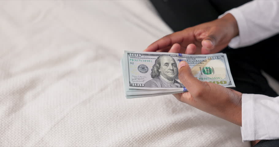 Photo from beside. american sillouhette counting cash money dolars in hands having low salary woman in debt having trouble. Royalty-Free Stock Footage #3394175845